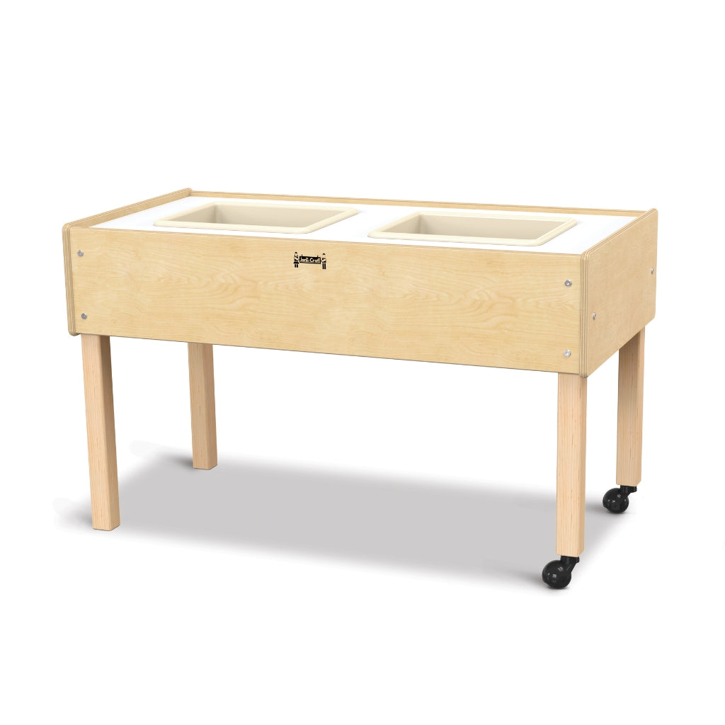 Wooden sensory table with white trays on a white background