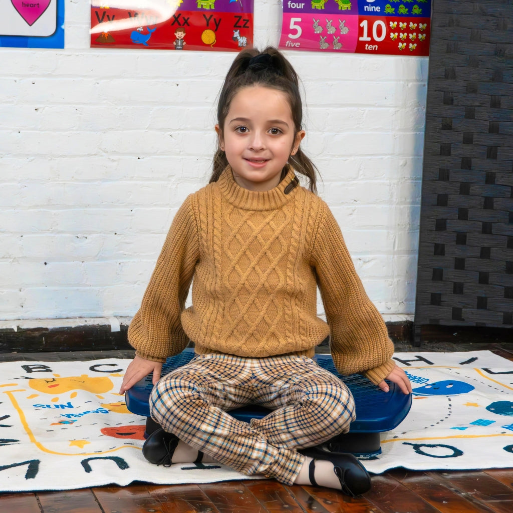 Girl sitting on a bouncy board