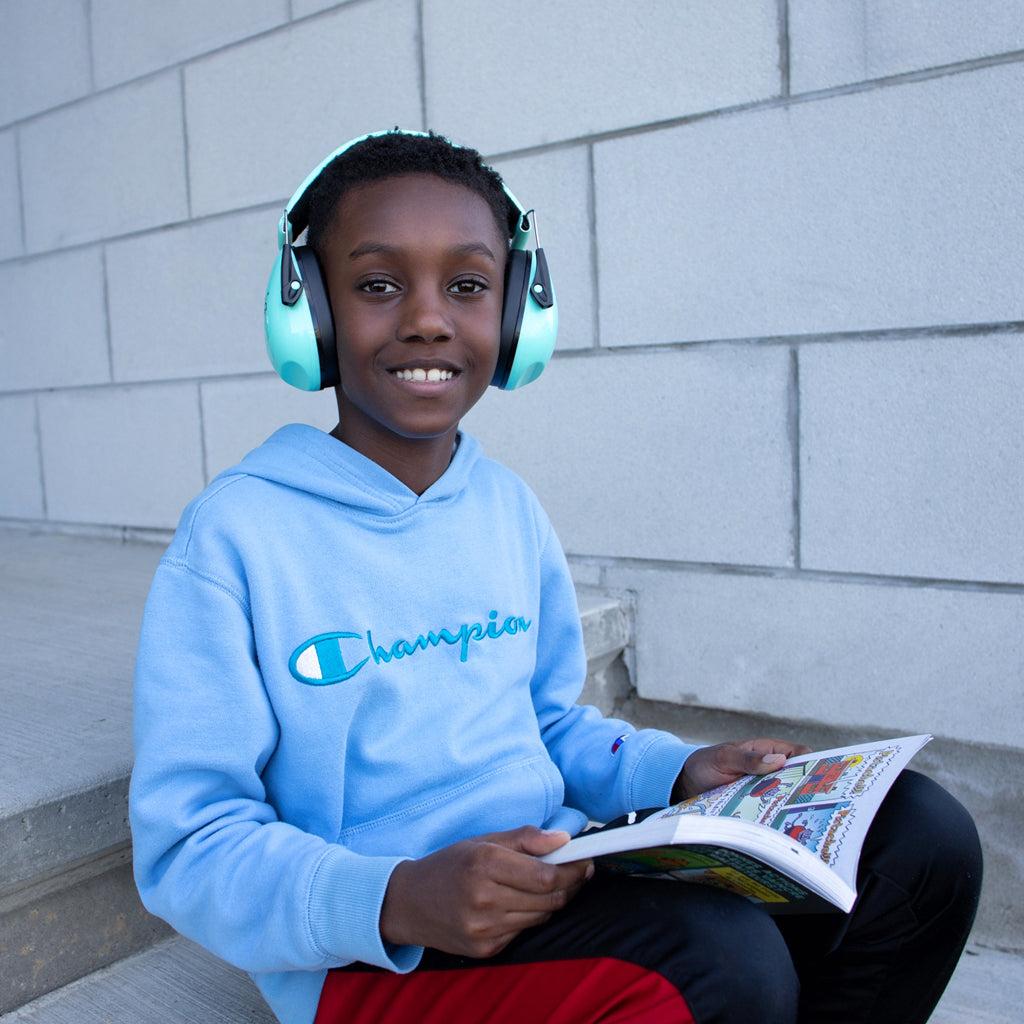 Boy smiling with noise canceling headphones on