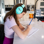 Doing homework at a kitchen island with sensory headphones
