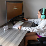 On the computer, wearing noise canceling headphones
