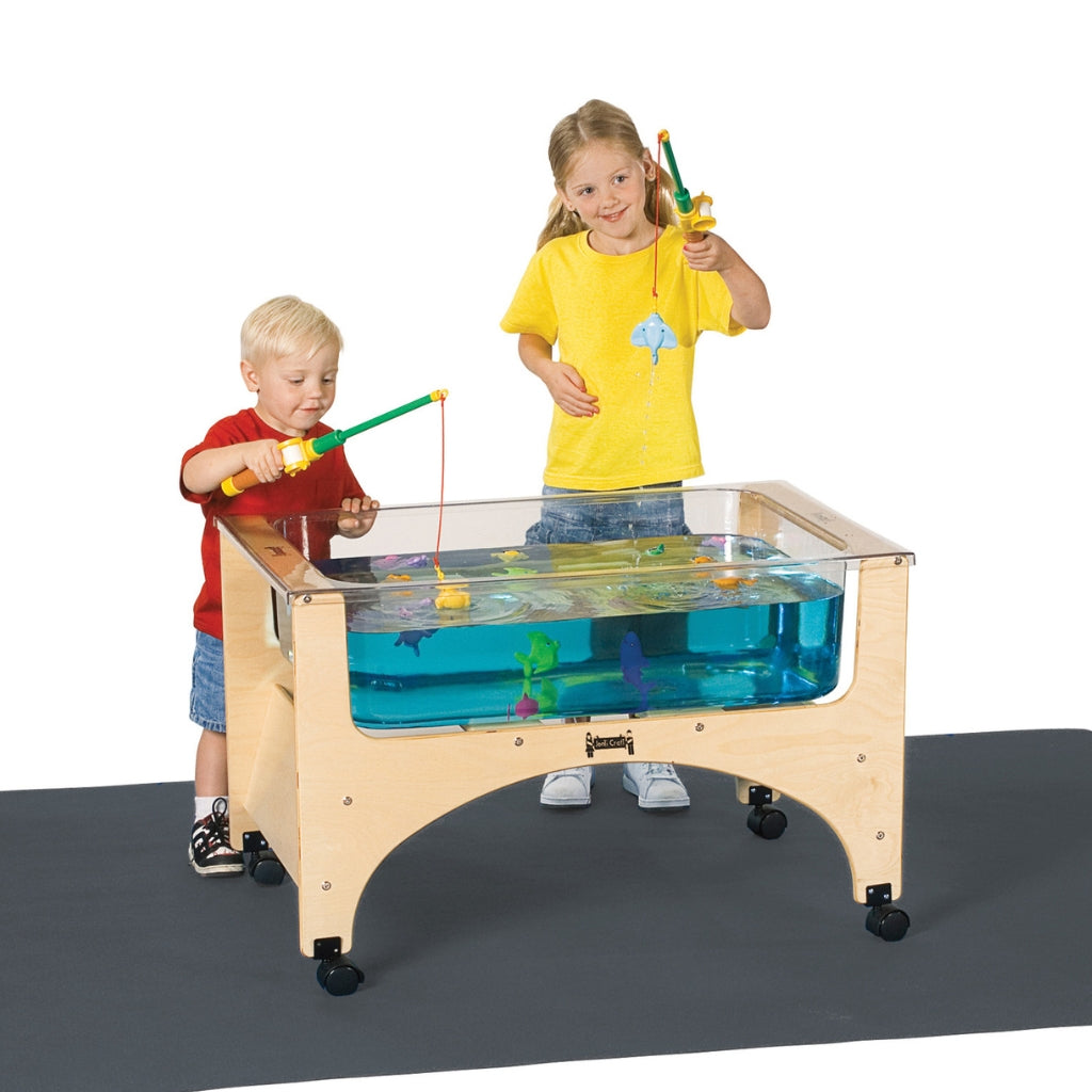 Two children playing a fishing game at a sensory table on a white background