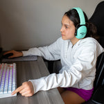 On the computer at a desk with sensory headphones