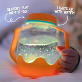 Orange sensory play jar. Lights up with water.