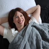 Woman lying in bed with weighted blanket