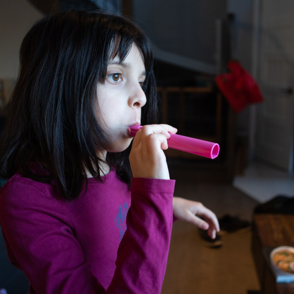 Girl blowing a whistle
